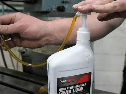 Lubrimatic Fluid Quart Pump fits standard quart bottles for easy handheld oil transfer shown in use