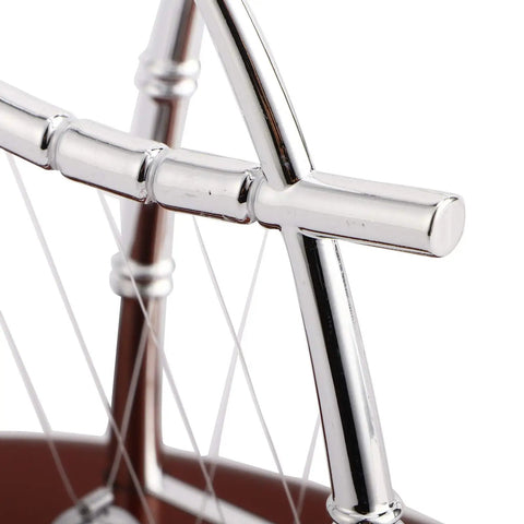 Close-up of polished frame of Newton's Cradle Desk Toy For Home Office Stress Relief With Metal Balance Balls Pendulum Demonstrating Momentum And Energy