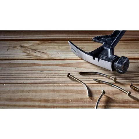 ToughSeries 22 Oz Demo Hammer With Magnetic Nail Starter Extended Claw For Board Grabbing shown pulling nails from wood surface
