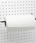 Extendable Pegboard Paper Towel Holder For Standard Pegboard Boss Shop Ready Fits 1/8 And 1/4 Inch Hole Spacing Holds Rolls Up To Seven Inch Diameter And Fourteen Inch Length Heavy Duty Metal With Black Finish Two Pack holding a paper towel roll on a pegboard