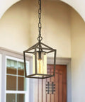 Outdoor Porch Pendant Light With Glass Shade, Vintage Metal Cage Lantern hanging at entryway, classic black finish.