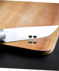 Heavy Duty Stainless Steel Bindery Rivets And Self Tapping Metal Handle Screws For Knockout DIY Crafts And Leather Work Built Like A Tank With Badass Grip Corrosion Resistant Hardware That Lasts Forever on a wooden cutting board next to a knife.