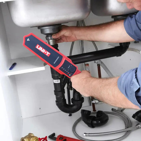 Plumber using Pipe Blockage Detector Tool for Plumbing Pros, 30 Meter Noninvasive Scanner under sink with PVC pipes.