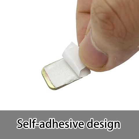 Hand holding self-adhesive weight from Easy Peasy Ceiling Fan Blade Balancing Kit Three Pack With Plastic Clips And Nine Metal Self Adhesive Weights Fix Unbalanced Fans Fast Includes 3 Clips And 9 Three Gram Weights Simple DIY Fan Repair Kit