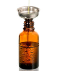 Close-up of a 30ml dark amber glass dropper bottle being filled with liquid through a funnel, part of 4 Pack 30ml Dark Amber Glass Dropper Bottles With 1 Funnel And 4 Labels.