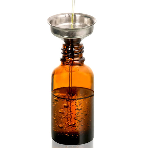Close-up of a 30ml dark amber glass dropper bottle being filled with liquid through a funnel, part of 4 Pack 30ml Dark Amber Glass Dropper Bottles With 1 Funnel And 4 Labels.