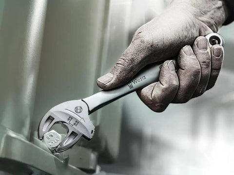Hand using Joker M Adjustable Wrench With Flexible Size Adjustment 13 To 16 Millimeters Auto Grip for hex bolt tightening.