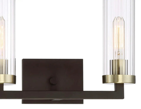 Close-up of Ainsley Court Vanity Bath Light Two Light Fixture in Aged Kinston Bronze with Brushed Brass Highlights, clear ribbed glass.