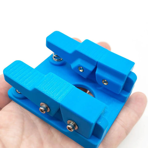 Super Cool Qinkyh Welding Wire Fixture And Soldering Table Clamp That Lets You Handle Any Diameter From 0.3 To 8mm With Ease, blue holder in hand.