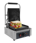 1800W Commercial Panini Grill Press With Stainless Steel Body And Cast Iron Plates grilling a sandwich with adjustable temp control.