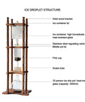 Generous Eighty Four Oz Cold Brew Drip Tower Iced Coffee Maker with hand blown glass vessel and solid wood base structure.
