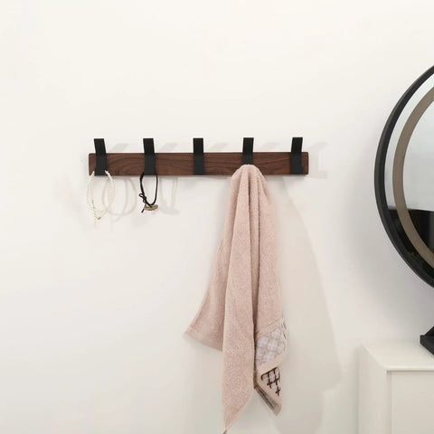 Wall Mount Coat Rack With Five Hooks 16.9 Inch Walnut Wood And Aluminum Built To Last Rustproof Coat Hanger Angled 45 Degree Design For Easy Hanging Of Coats Hats Bags Keys Modern Black Finish mounted on a wall with hooks holding a towel and accessories.