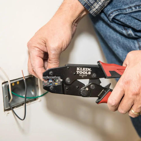 Person using Pro-Grade Wire Stripper And Ratcheting Crimper Kit For Insulated Terminals on electrical wiring
