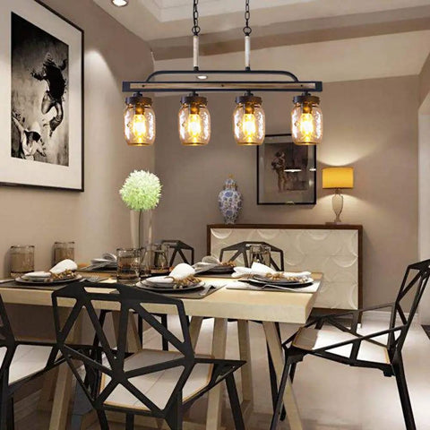 Farmhouse Black Mason Jar Chandelier For Kitchen Island And Dining Table Rustic Linear Pendant Light with warm glow over dining area