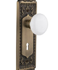 Egg And Dart Door Plate With Keyhole And White Porcelain Knob Passage Style Door Hardware Set Two And Three Quarter Backset Antique Brass Finish
