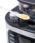Close-up of Grind And Brew 15 Cup Coffee Maker With Timer And Auto Off Stainless Steel Black Coffee Machine adjusting settings.