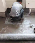 Person applying Top Shelf Waterproof Membrane Roll For Concrete Slabs And Showers Ready To Roll Tile Underlayment on floor.