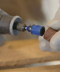 Close-up of hands using EZ SpeedClic Sanding Bands And Mandrel Set With Two 13 Mm Sanding Bands Grit 60 And 120 on wood