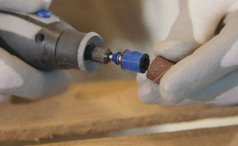 Close-up of hands using EZ SpeedClic Sanding Bands And Mandrel Set With Two 13 Mm Sanding Bands Grit 60 And 120 on wood