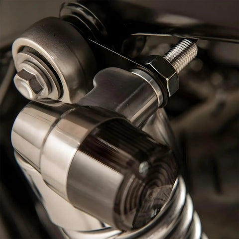 AUCELI rear turn signal mounting brackets installed on chrome motorcycle hardware; bolt and hex nut visible