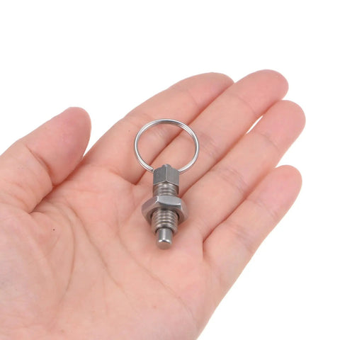 Two Pack Built Tough Stainless Steel Spring Plungers With Pull Ring M8X1.25 Thread held in hand, showcasing smooth action and flat head.