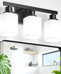 Straight Up Solid 3 Light Bathroom Vanity Lights With Square Frosted Glass Shades Matte Black Wall Sconces over a mirror in a modern bathroom.