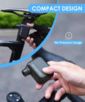 Person holding a Pocket Sized Electric Bike Pump With 100 PSI, Ultra Portable Road Bike Tire Inflator, Compact, No Pressure Gauge, Fits in hand.