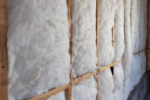 Pro Grade Fiberglass Batt Insulation R13 Rating snugly fits standard two by four interior walls, showcasing durable kraft facing.