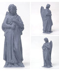 Grey angel statue figurine with wings, standing on base; shown from front and side views.