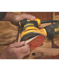 Close-up of 5 Inch Orbital Sander With 3.0 Amp Motor Delivers 12,000 OPM used on wooden surface for finishing cabinets