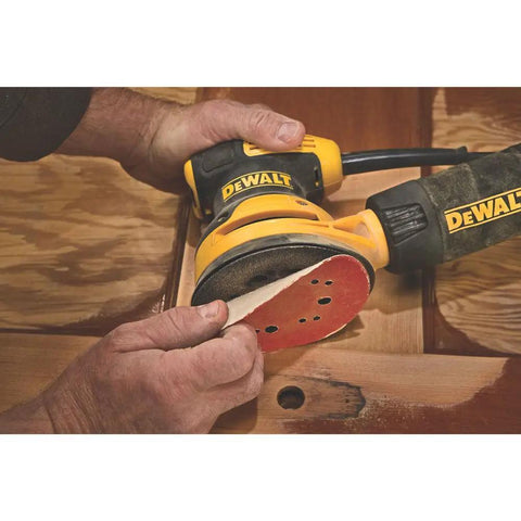 Close-up of 5 Inch Orbital Sander With 3.0 Amp Motor Delivers 12,000 OPM used on wooden surface for finishing cabinets