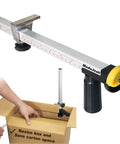 Box Resizer Tool With Safety Blade Cover And Scoring Wheel For Custom Box Size Up To 10 Inches Deep, No Guesswork Reducing Cartons To Exact Dimensions For Ecommerce, Retail And Warehouse Packing. Metal box resizer with ruler and scoring wheel over carton