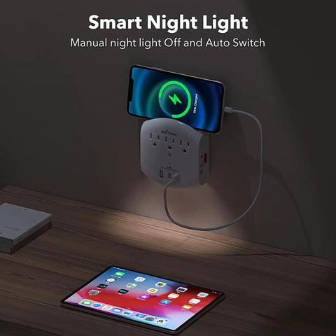 Six In One Outlet Extender With Three USB Ports And Three Grounded Outlets, Dusk To Dawn Night Light charging a phone