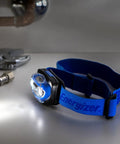 Vision LED Headlamp 200 Lumen 4 Pack With 12 AAA Batteries Included, adjustable hands-free light on table