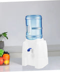 Portable Water Dispenser And Compact Bucket Holder Faucet For Outdoor Camping And RV Use on a kitchen countertop.