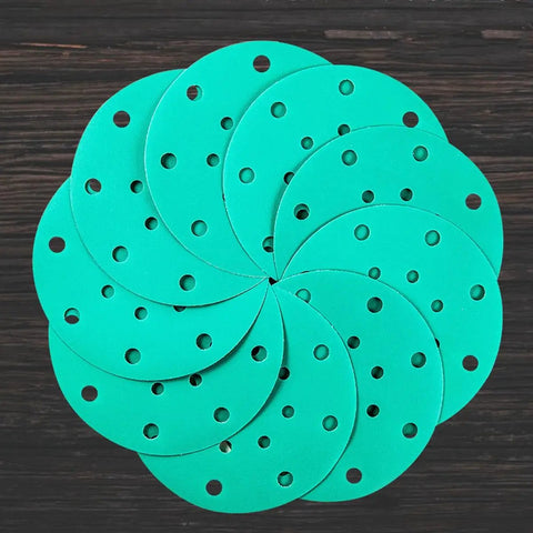 Get A Solid 20 Pack of 6 Inch Hook And Loop Sanding Discs With Assorted Grits From 60 To 2000 showing circular green discs with holes.