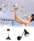 Person installing light bulbs on ceiling fixture with two additional black wall lamps below; Dope Double End Threaded Lamp Rod Kit 400mm.