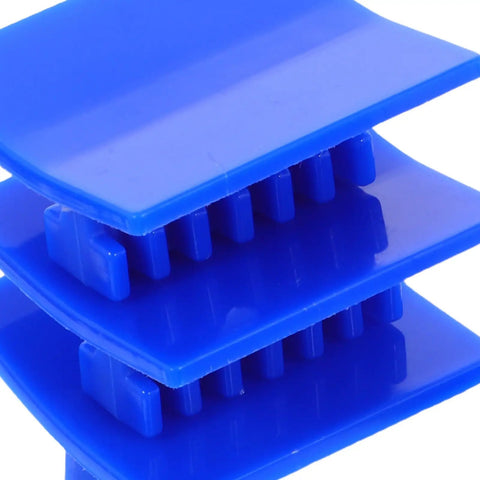 Close-up of blue plastic dent puller tabs from Pro-Grade Four-Piece Automotive Dent Removal Kit for damage-free auto body repair.