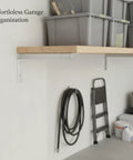 Sturdy Stainless Steel Shelf Bracket For Vertical Track Systems Ideal For Closet And Pantry Storage, Silver Finish image in garage