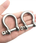 Two Pack Three Eighth Inch Screw Pin Anchor Shackle Premium 304 Stainless Steel Heavy Duty Rigging Workhorse Marine Boat Towing Safety Hardware Built Tough Outdoors held in hand.