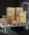 Heavy Duty Flatbed Platform Cart Folds Compact Yet Built Tough loaded with boxes on a cold rolled steel deck, ideal for warehouse use.