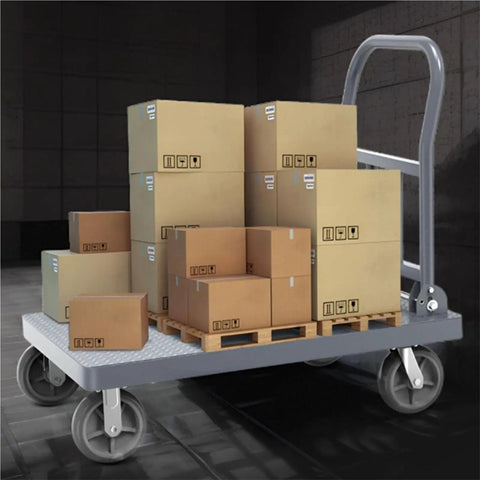Heavy Duty Flatbed Platform Cart Folds Compact Yet Built Tough loaded with boxes on a cold rolled steel deck, ideal for warehouse use.