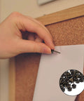 Hand using 250 Piece Hand Forged Bronze Upholstery Tacks For Furniture And Sofas to pin paper on a cork board.
