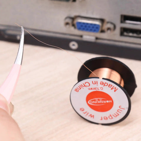 Tweezers holding a strand of the 0.1mm 5Pcs Ultra Thin Soldering Wire Set Copper Jumper Wires For PCB Repair Mobile Phone And Computer Electronics Precision Flexible Link Jump Wires Pro Grade DIY Welding Tools with a spool visible in the background.