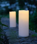 Huge Outdoor Flameless LED Pillar Candles 4X10 Inches IP44 Waterproof with Remote and Timer on stone wall in garden setting
