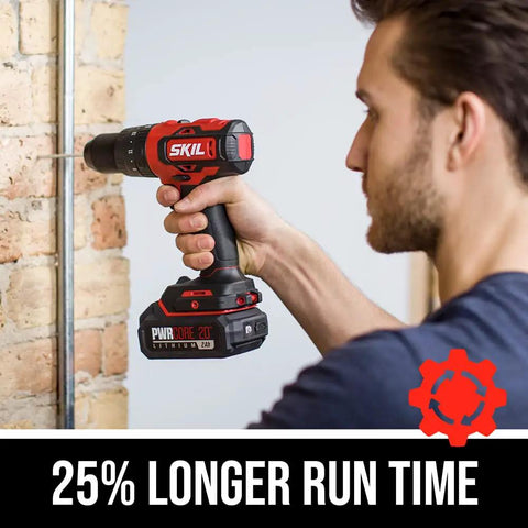 Man using PWR CORE 20 Brushless 20V Cordless Hammer Drill Kit With Two Ah Lithium Battery And PWR Jump Charger on brick wall