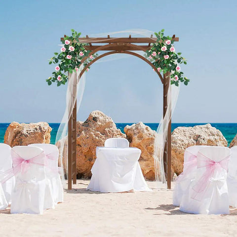 85 Inch Wooden Garden Arbor Arch for Outdoor Weddings and Ceremonies decorated with climbing plants on a beach setting