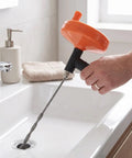 Heavy Duty Manual Drain Snake Auger For Home Plumbing Quick Clog Remover, ergonomic grip in use over sink.