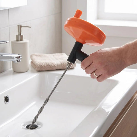 Heavy Duty Manual Drain Snake Auger For Home Plumbing Quick Clog Remover, ergonomic grip in use over sink.