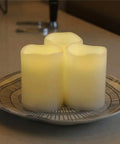Outdoor IP44 Flameless LED Pillar Candles Set Of 3 With Remote And Timer Warm White Weather Resistant Plastic Candles That Wont Melt Waterproof 3 By 4 Inches Battery Operated on a plate